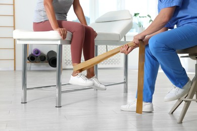 Photo of Physiotherapist working with senior patient in rehabilitation center, closeup