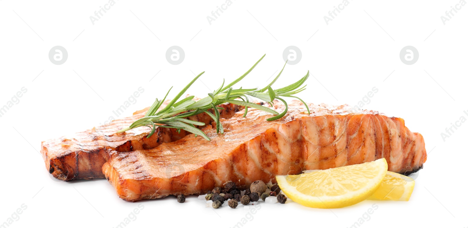 Photo of Delicious grilled salmon fillets with peppercorns, lemon and rosemary isolated on white