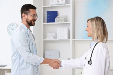 Photo of Doctor shaking hands with patient in hospital