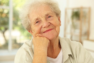 Photo of Portrait of beautiful senior woman against blurred background