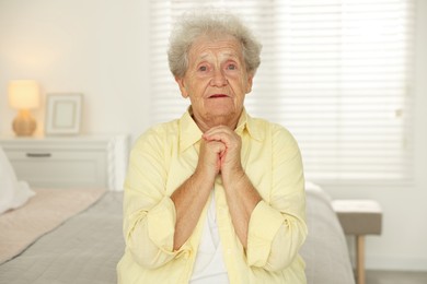 Portrait of emotional senior woman at home