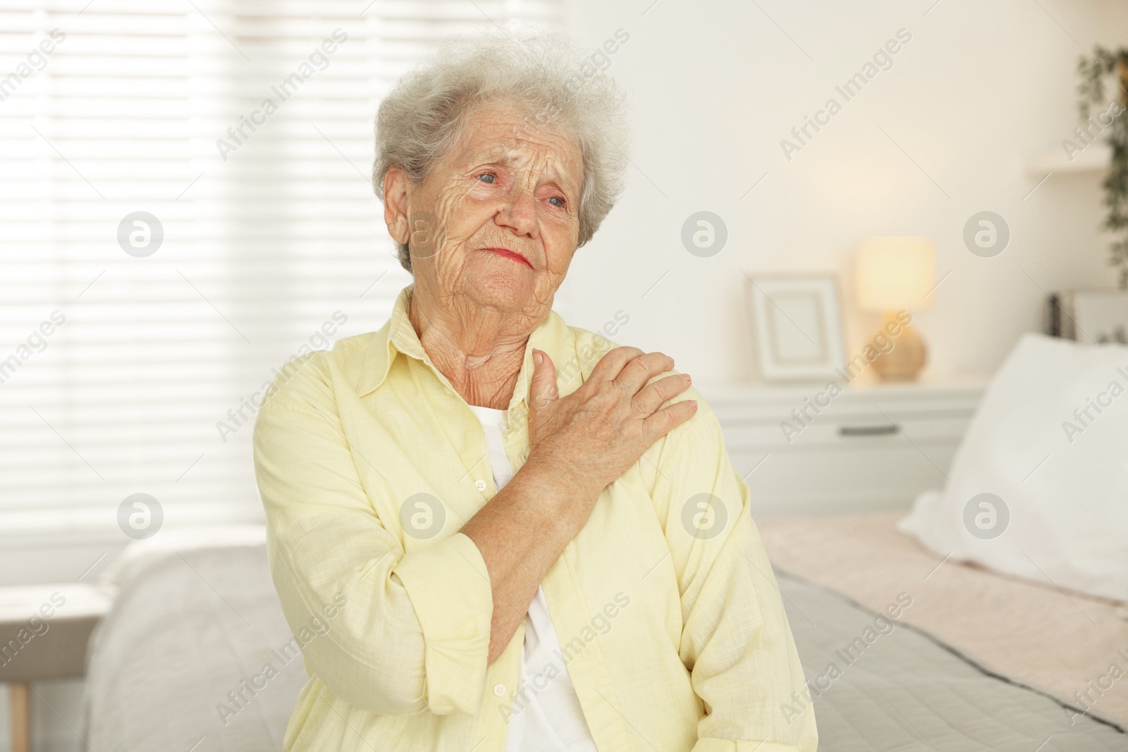 Photo of Portrait of sad senior woman at home