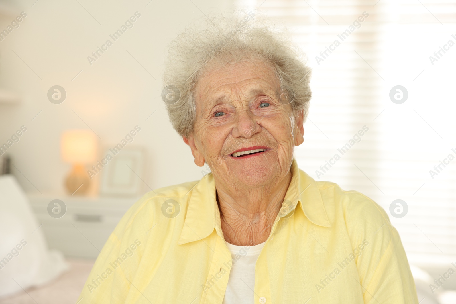 Photo of Portrait of smiling senior woman at home