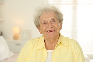 Portrait of smiling senior woman at home