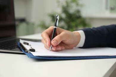 Photo of Businesswoman working at white table indoors, closeup view