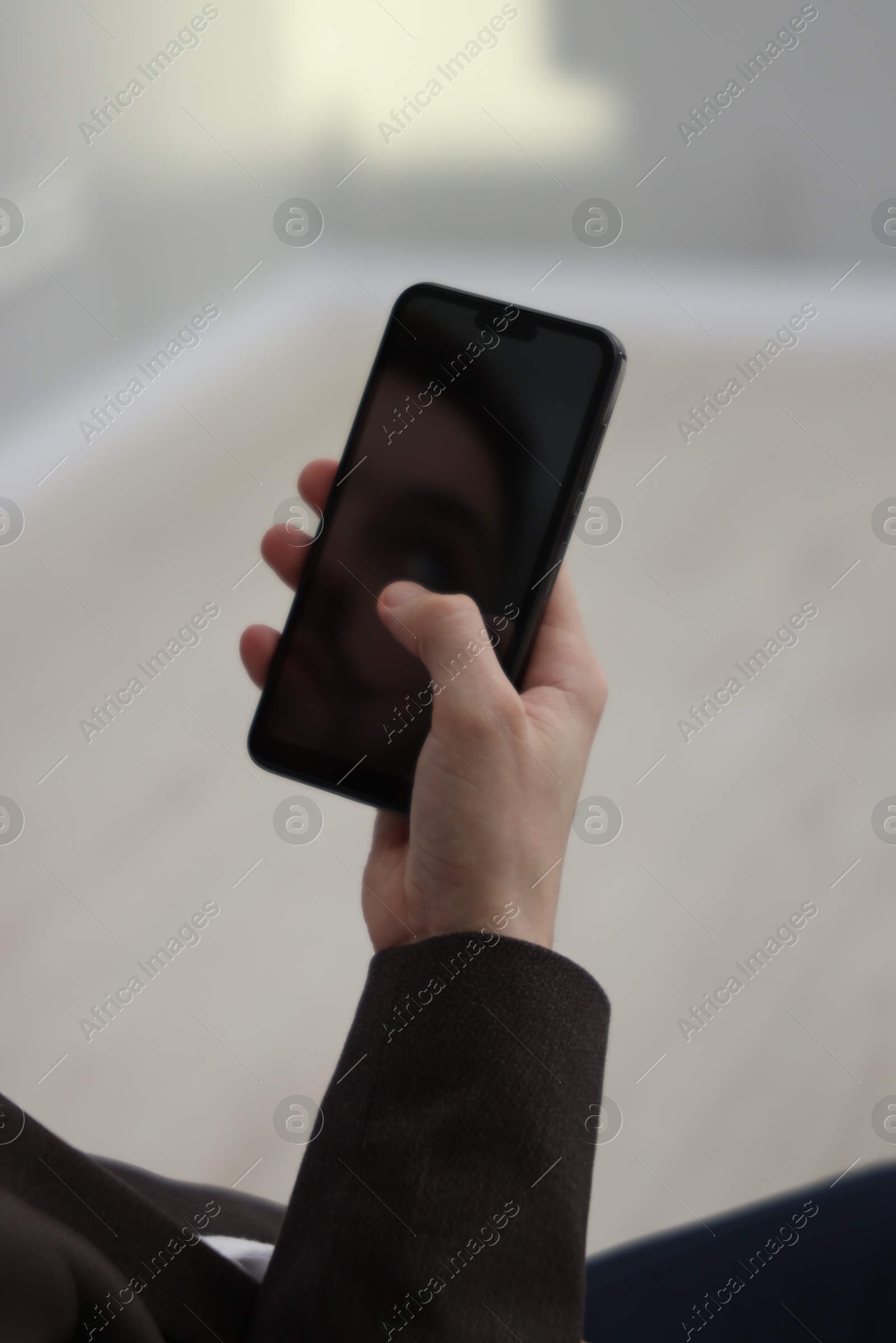 Photo of Businessman using smartphone on blurred background, closeup. Modern technology