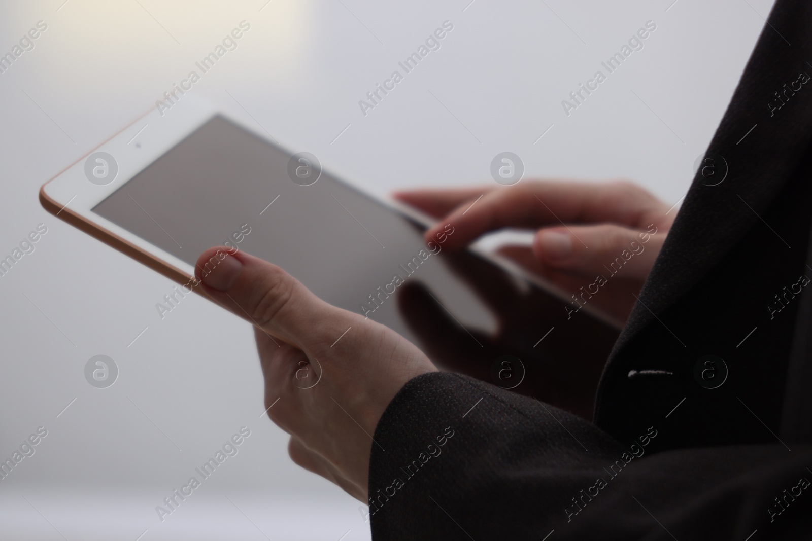 Photo of Businessman using tablet indoors, closeup. Modern technology