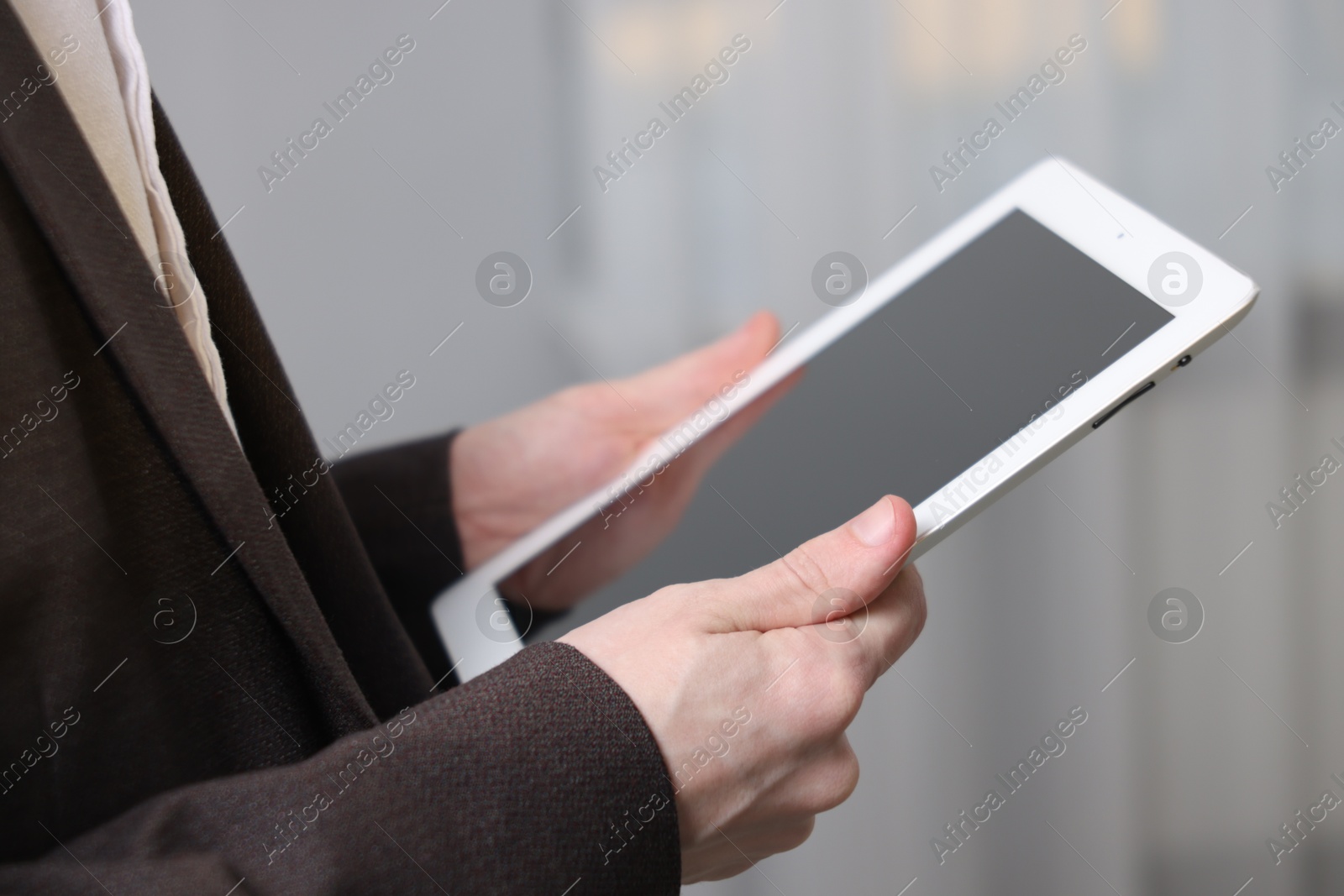 Photo of Businessman using tablet indoors, closeup. Modern technology