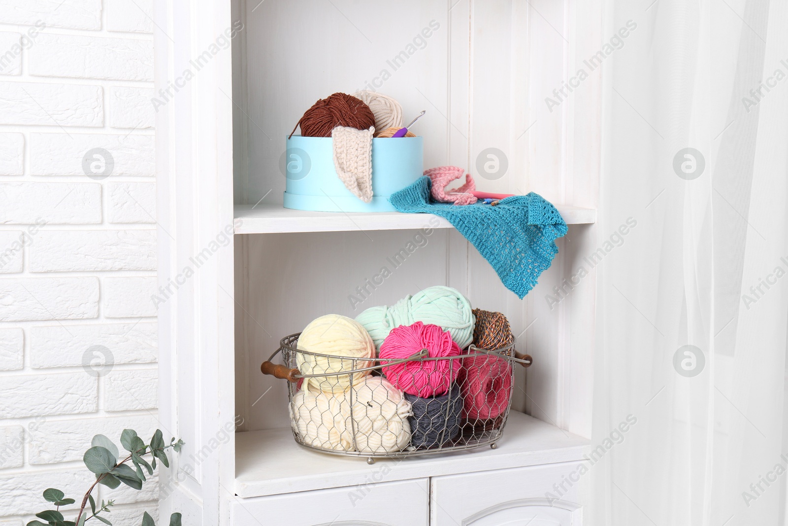 Photo of Shelving unit with different yarns, pattern samples and crochet hooks