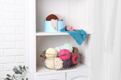 Photo of Shelving unit with different yarns, pattern samples and crochet hooks