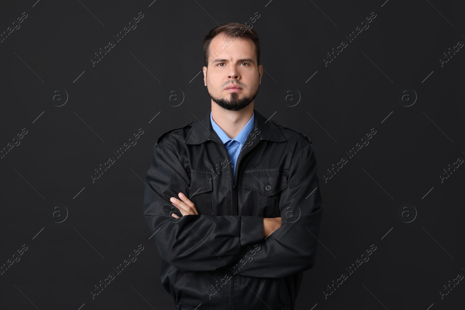 Photo of Security guard in uniform on black background