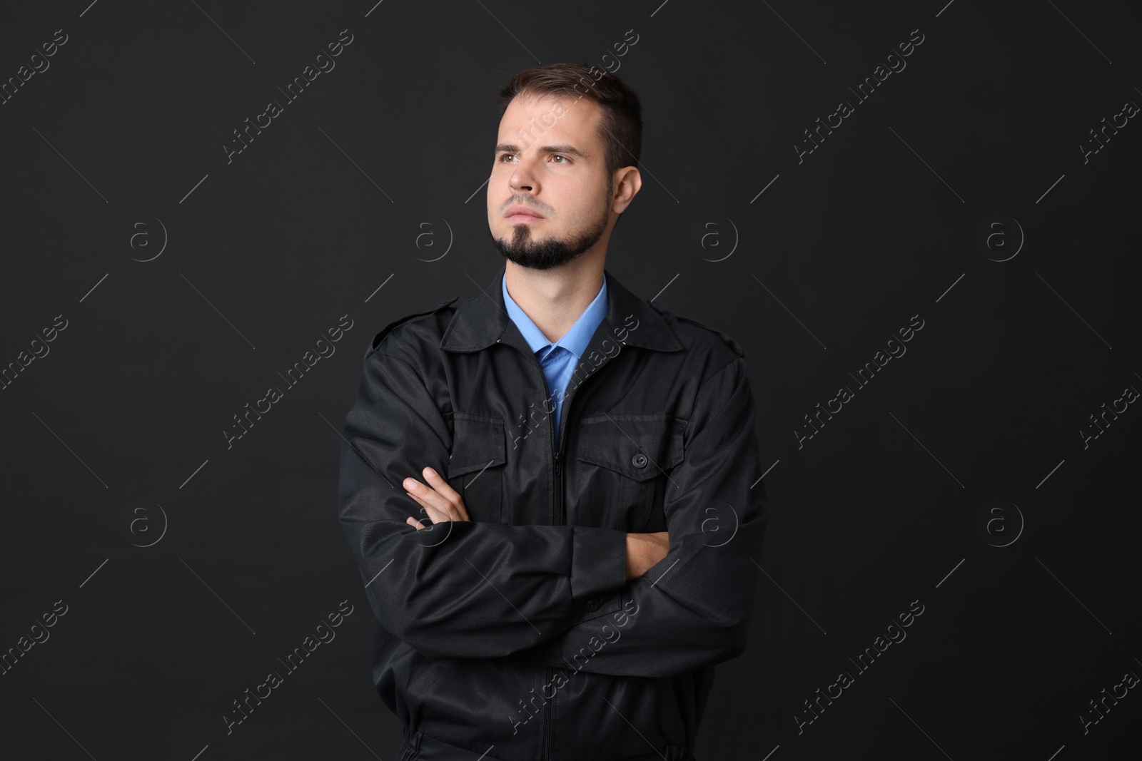 Photo of Security guard in uniform on black background