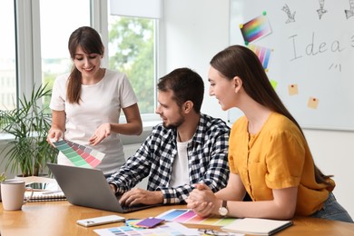 Photo of Group of designers working together in office