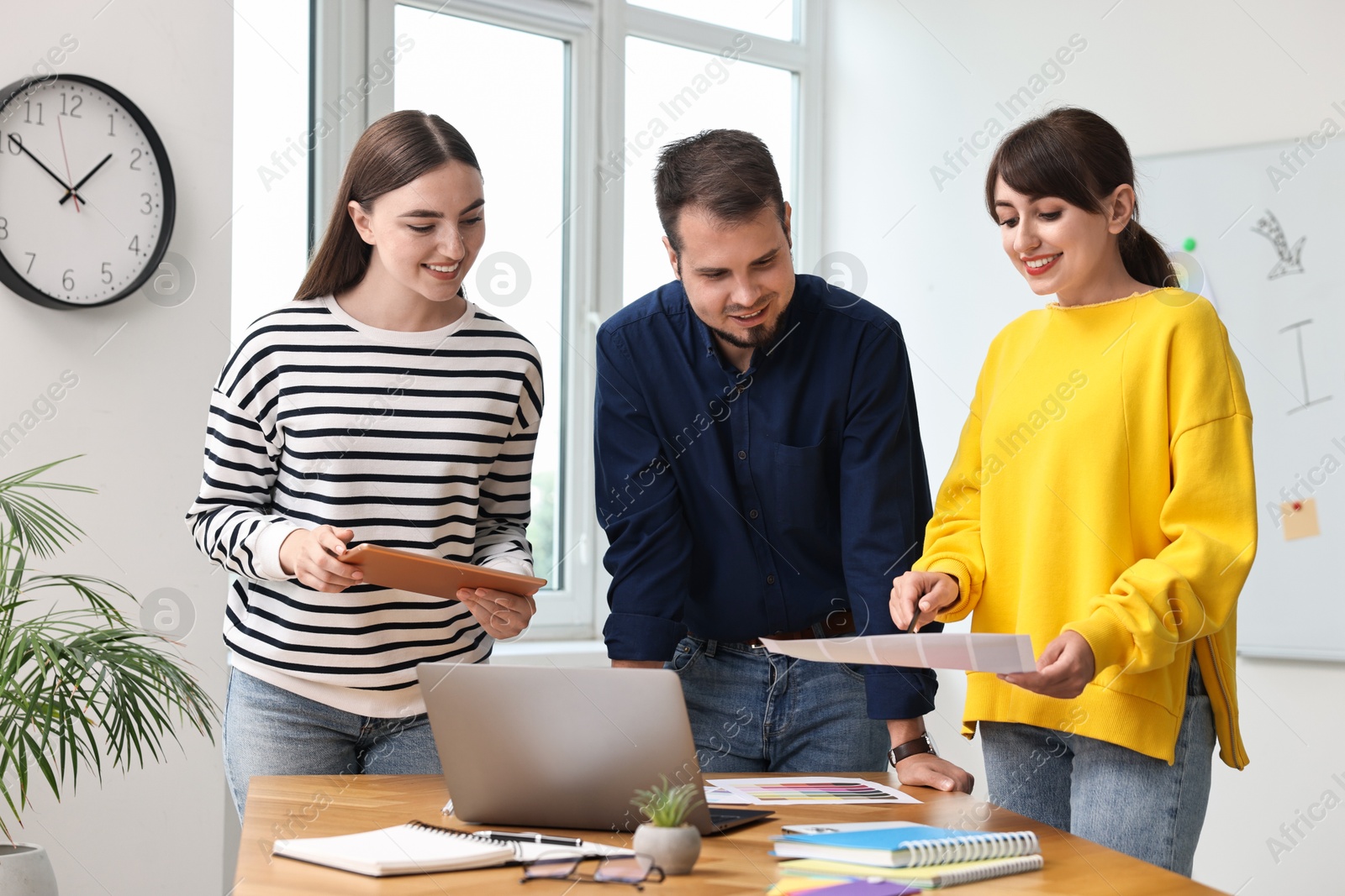 Photo of Group of designers working together in office