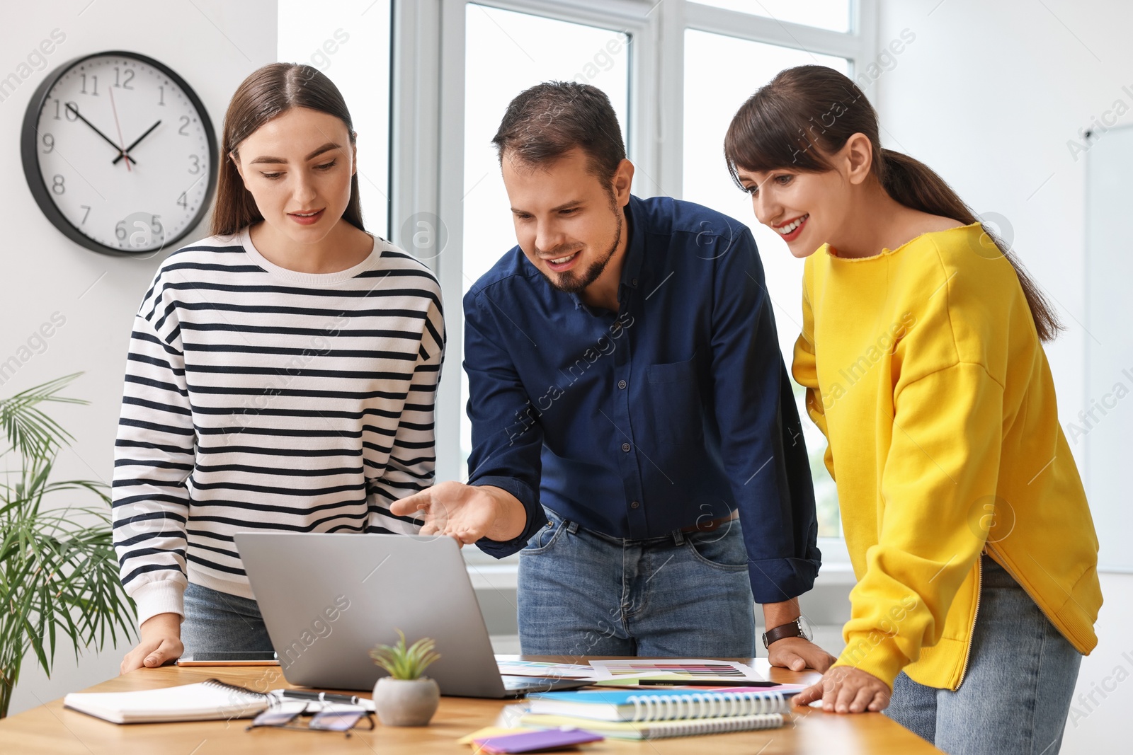 Photo of Group of designers working together in office