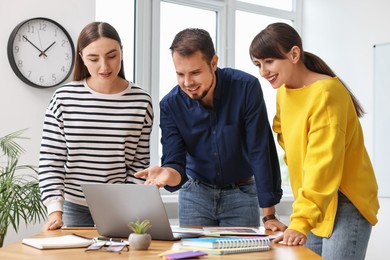 Photo of Group of designers working together in office