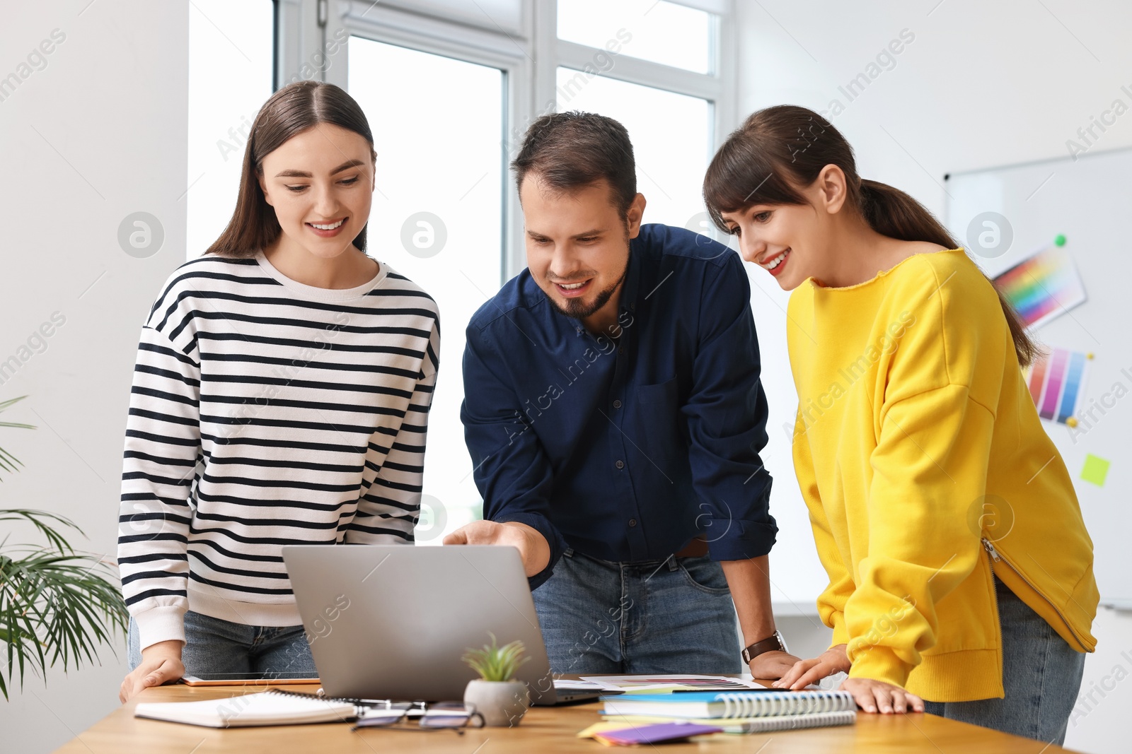 Photo of Group of designers working together in office