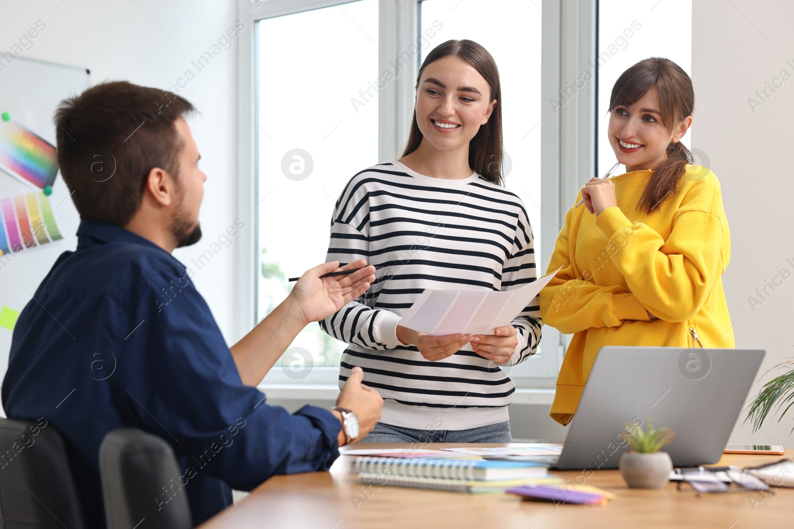 Photo of Group of designers working together in office