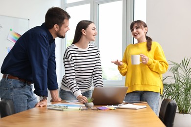 Photo of Group of designers working together in office