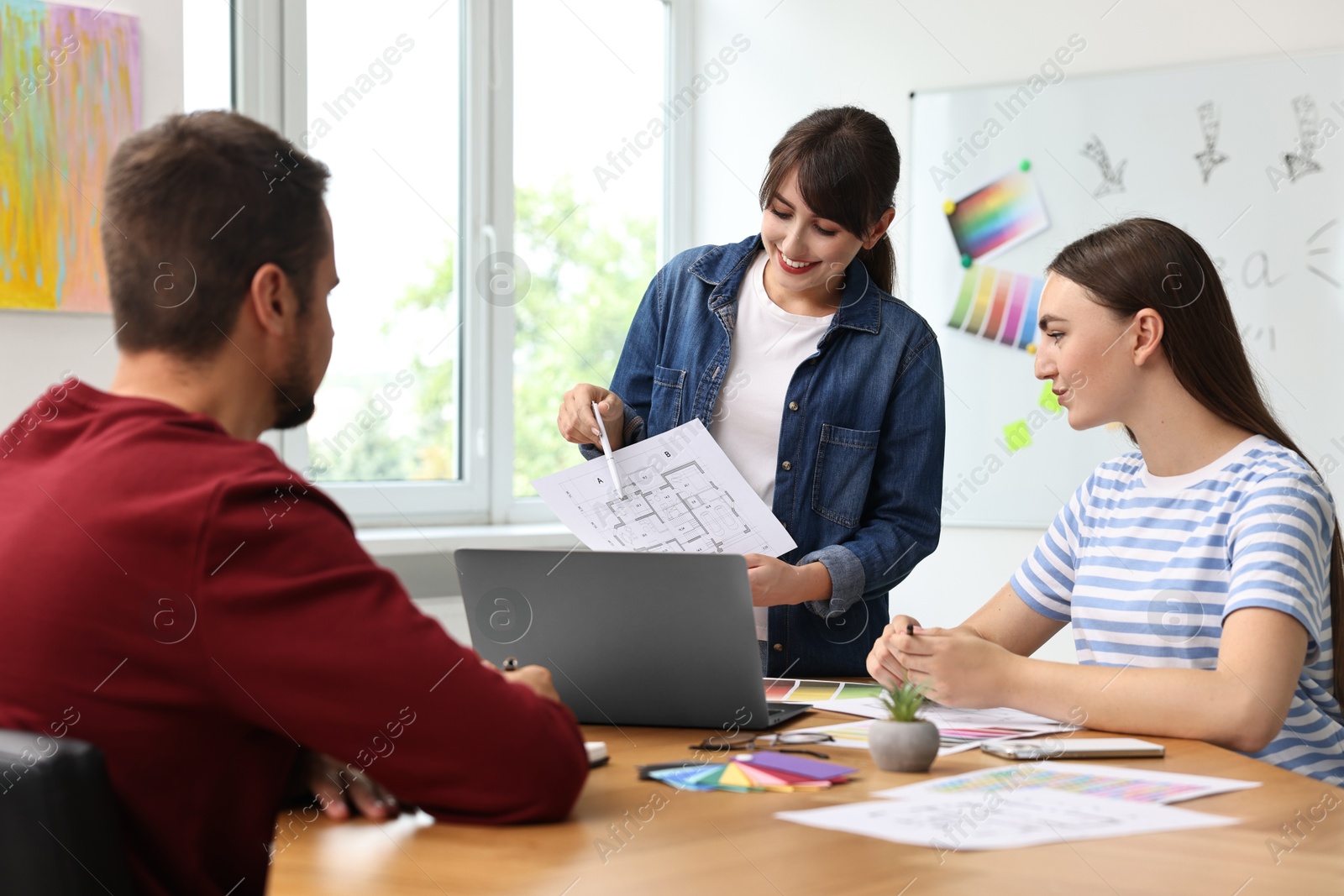 Photo of Group of designers working together in office