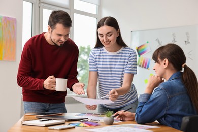 Photo of Group of designers working together in office