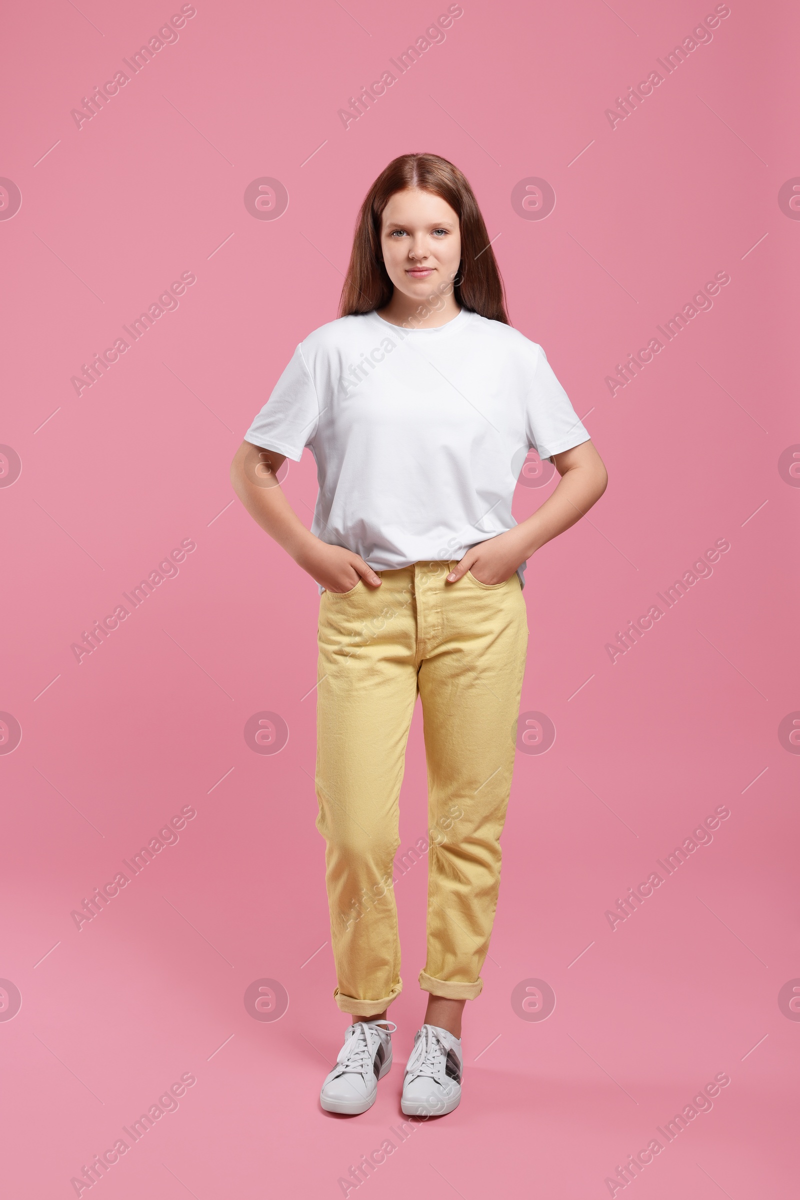 Photo of Portrait of teenage girl on pink background