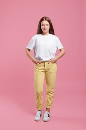 Photo of Portrait of teenage girl on pink background