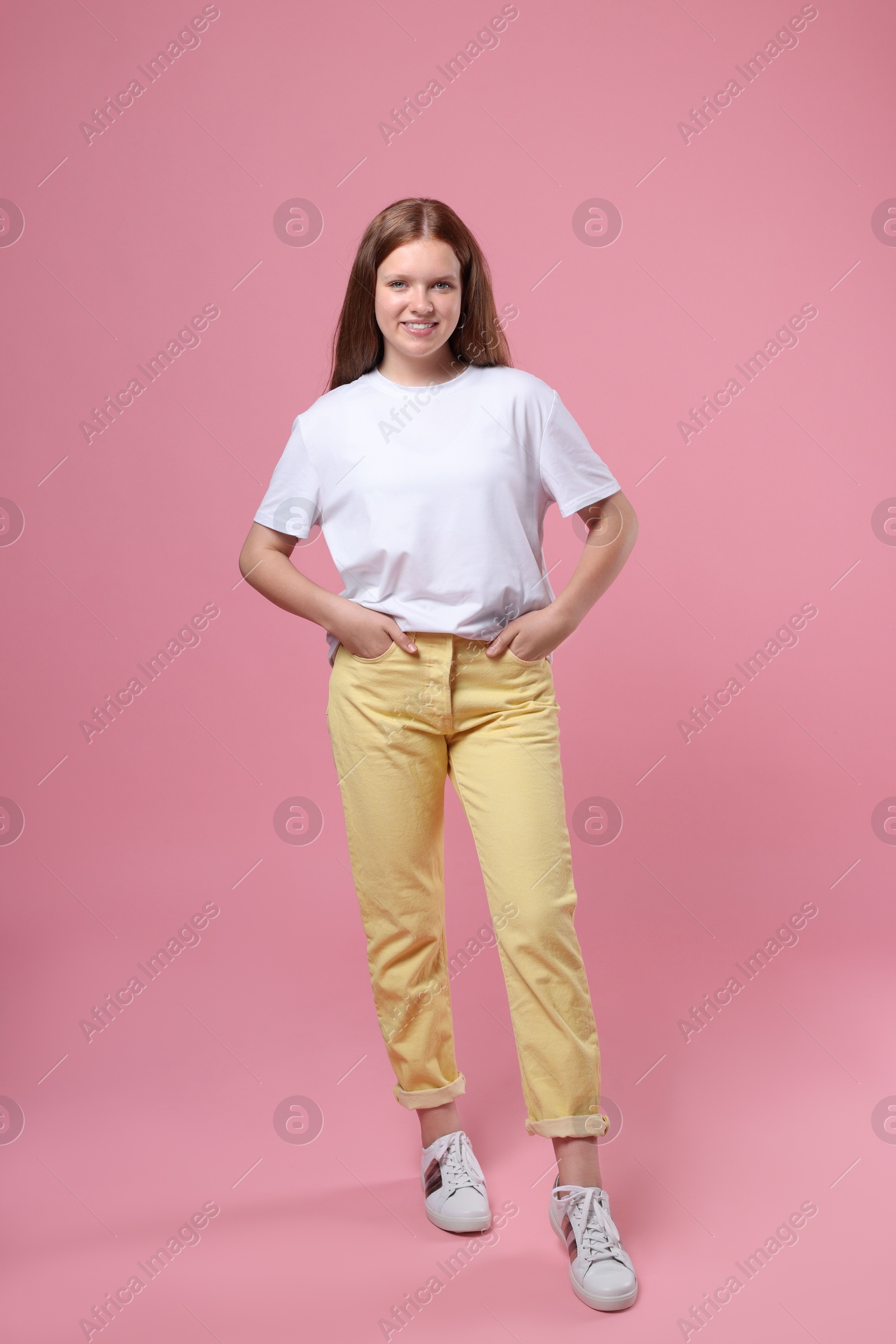 Photo of Portrait of teenage girl on pink background