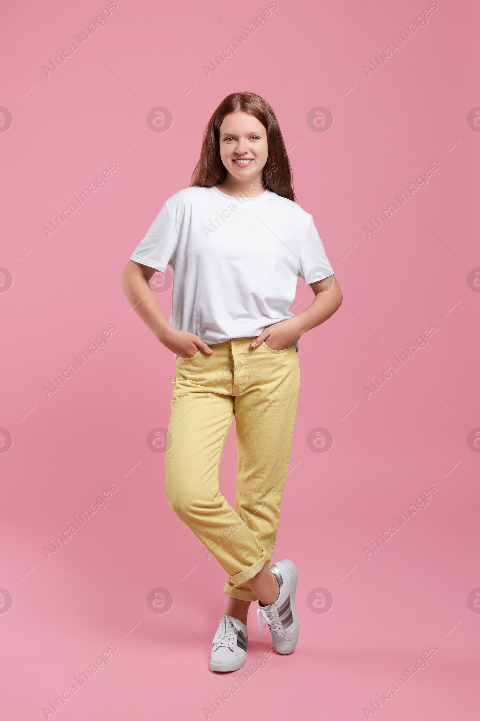 Photo of Portrait of teenage girl on pink background