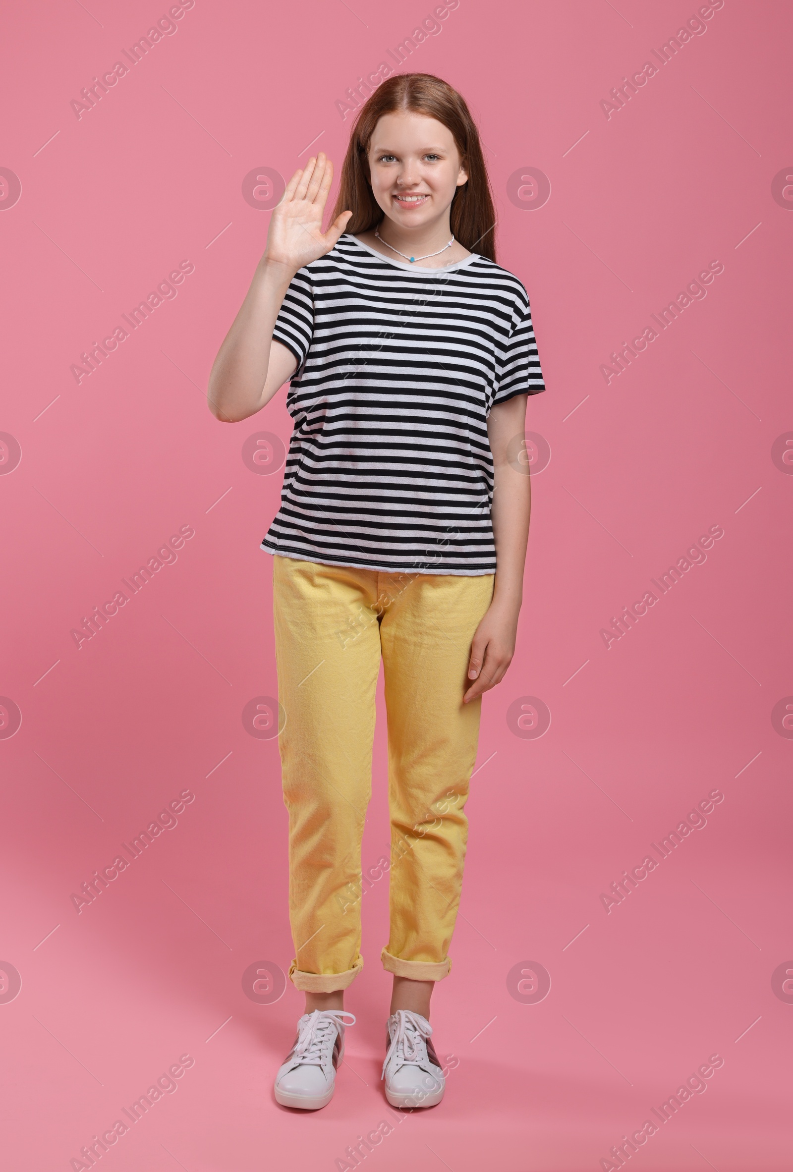 Photo of Portrait of teenage girl on pink background