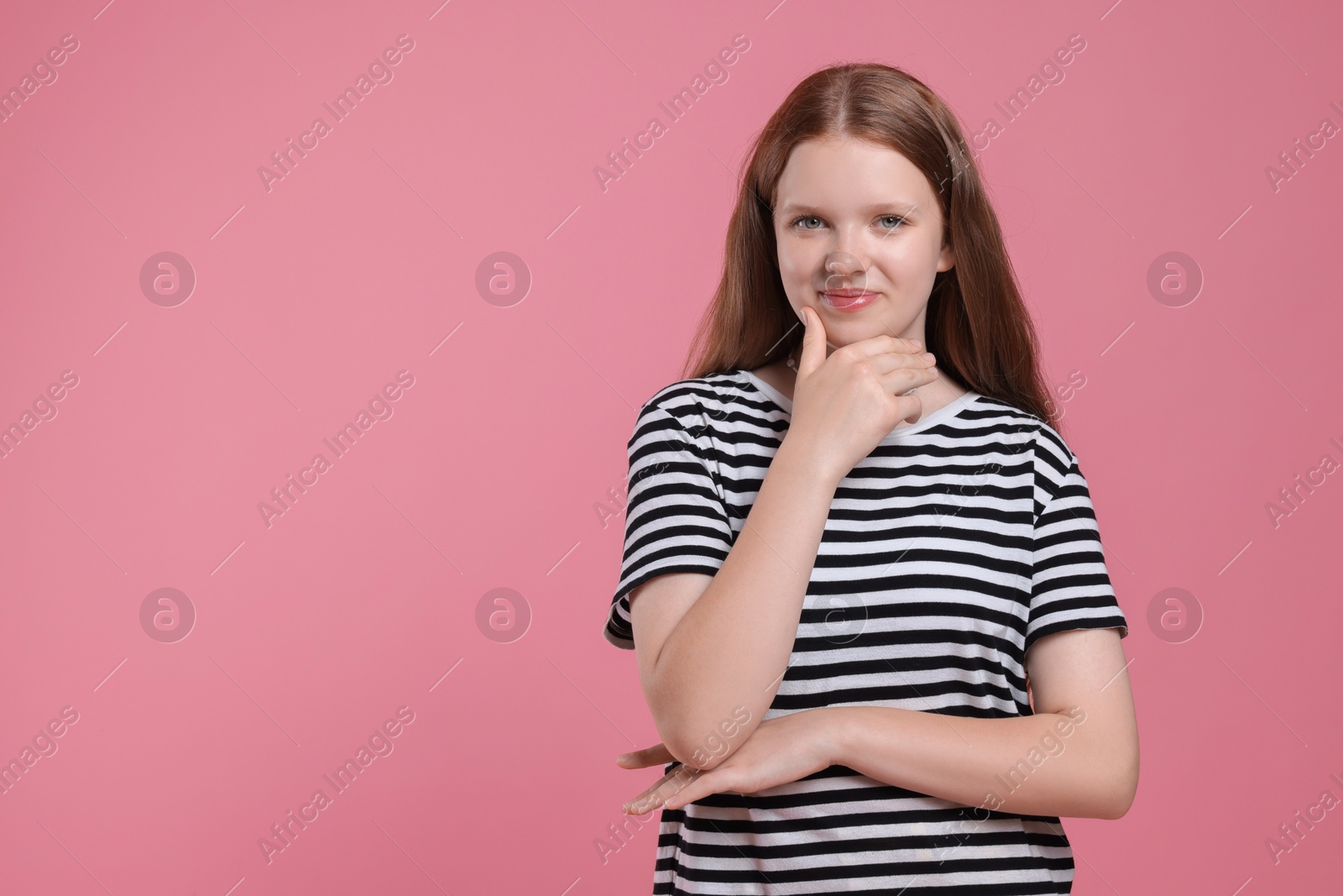 Photo of Portrait of teenage girl on pink background, space for text