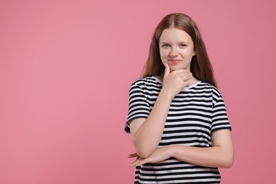 Photo of Portrait of teenage girl on pink background, space for text