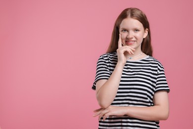 Photo of Portrait of teenage girl on pink background, space for text