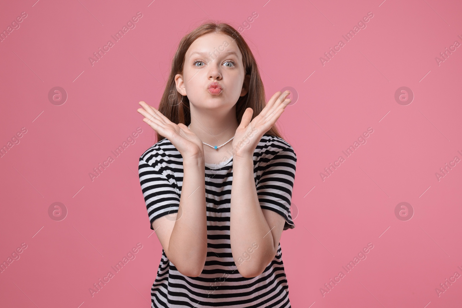 Photo of Portrait of teenage girl on pink background