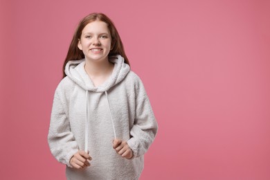 Photo of Portrait of teenage girl on pink background, space for text