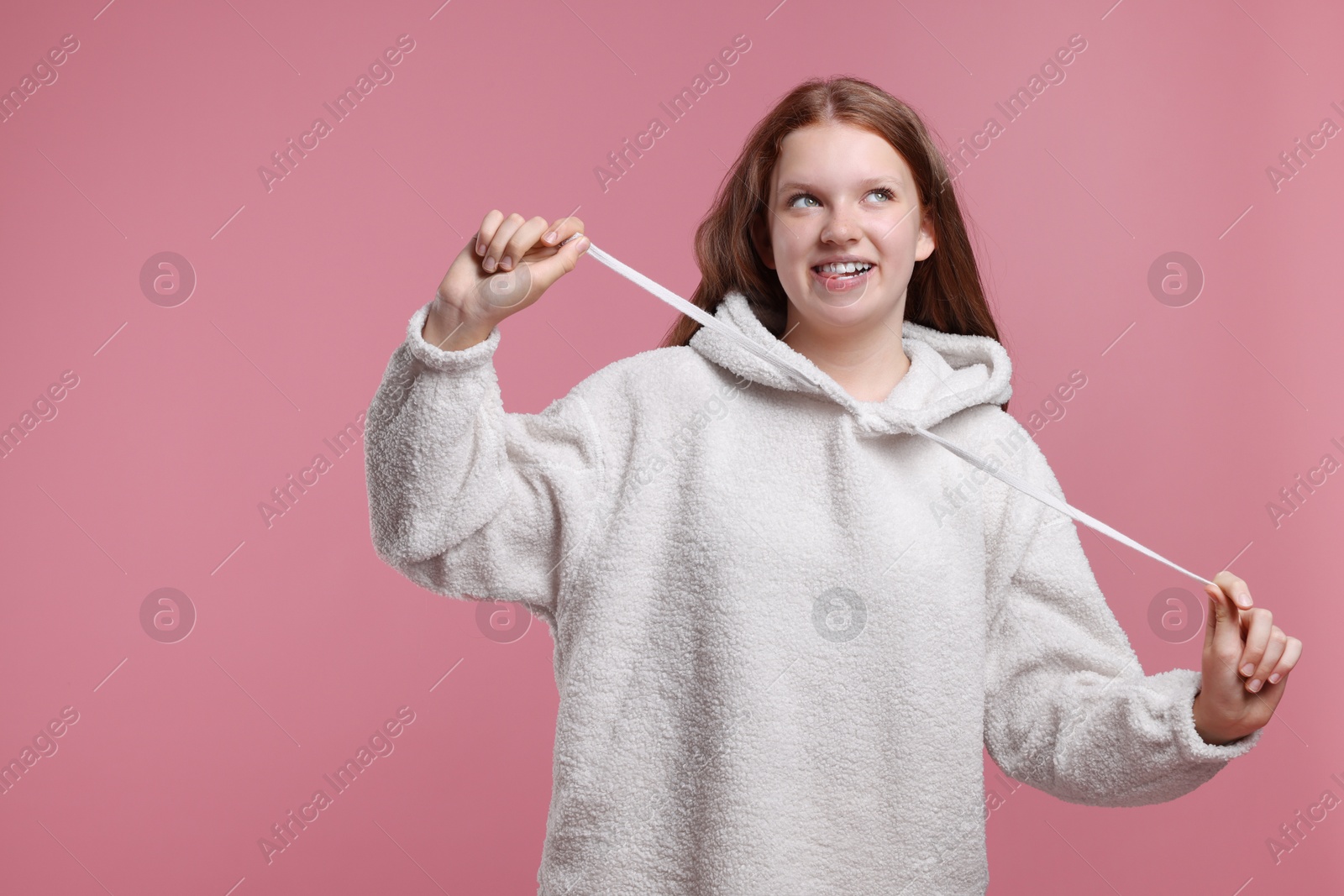 Photo of Portrait of teenage girl on pink background