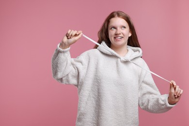 Photo of Portrait of teenage girl on pink background