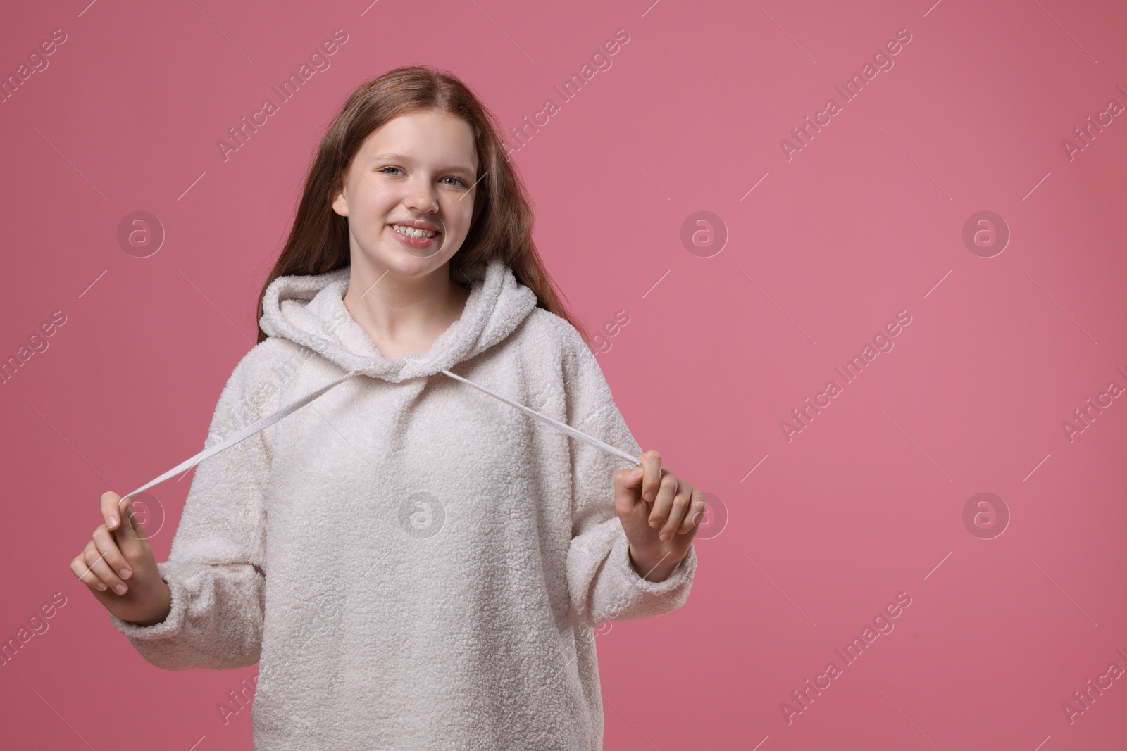 Photo of Portrait of teenage girl on pink background, space for text