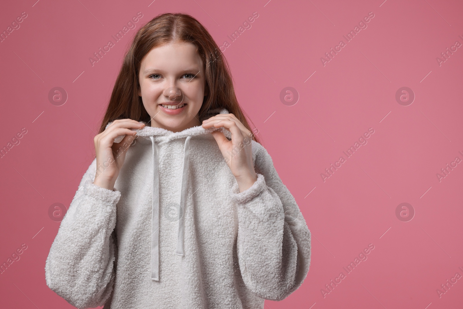 Photo of Portrait of teenage girl on pink background, space for text