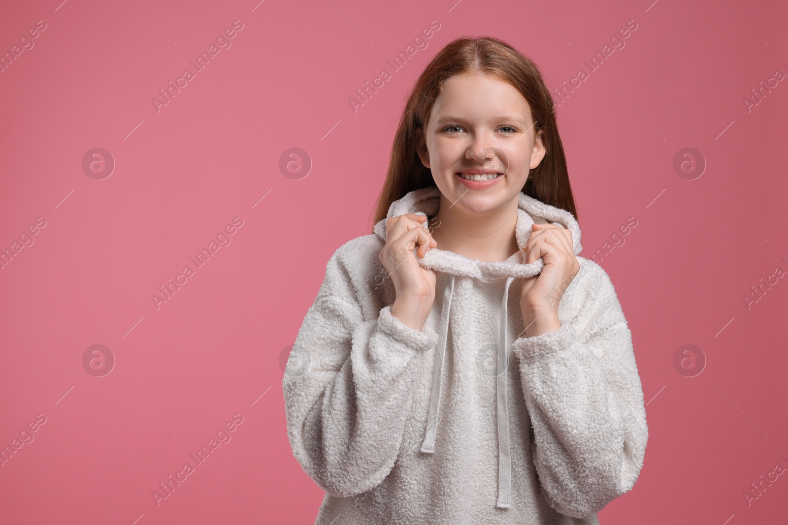 Photo of Portrait of teenage girl on pink background, space for text