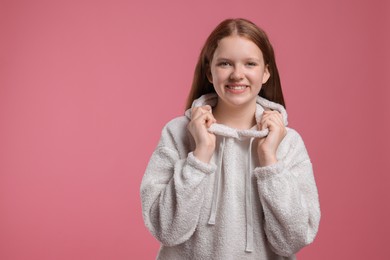 Photo of Portrait of teenage girl on pink background, space for text