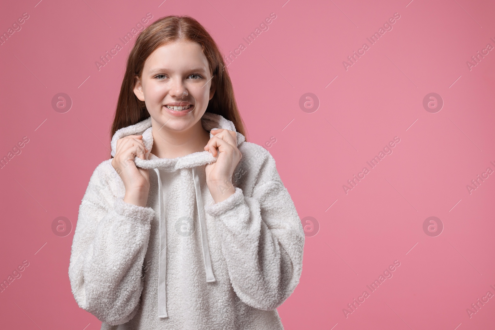 Photo of Portrait of teenage girl on pink background, space for text