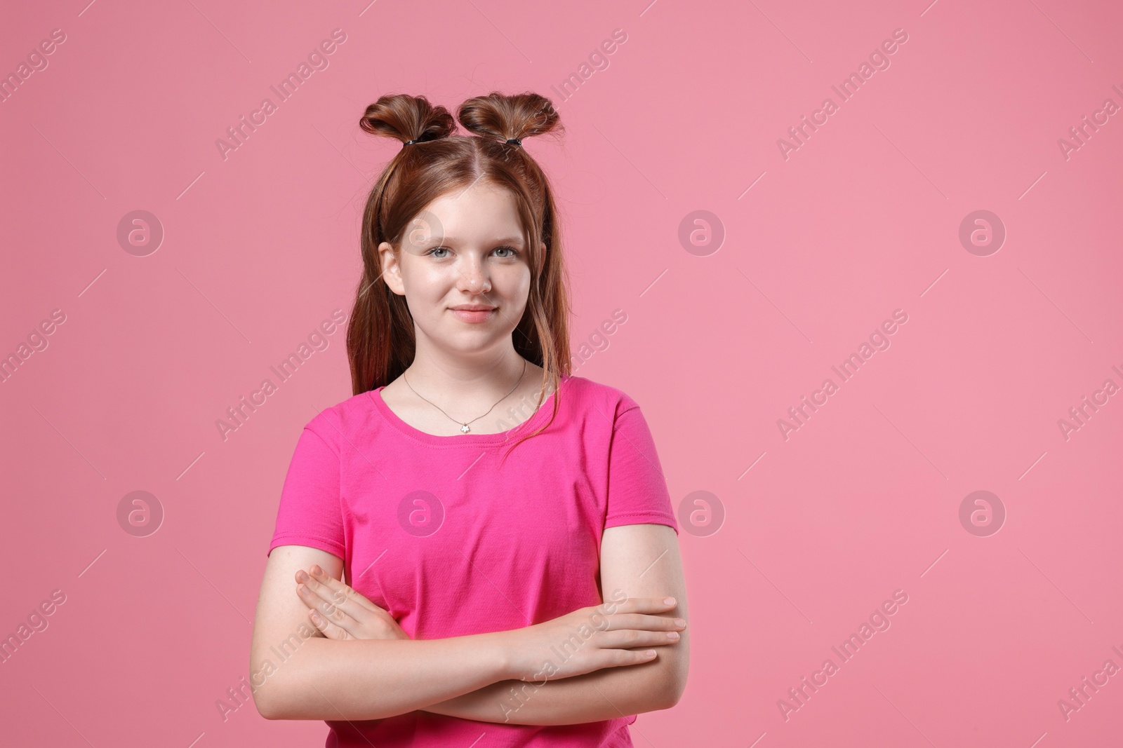 Photo of Portrait of teenage girl on pink background, space for text