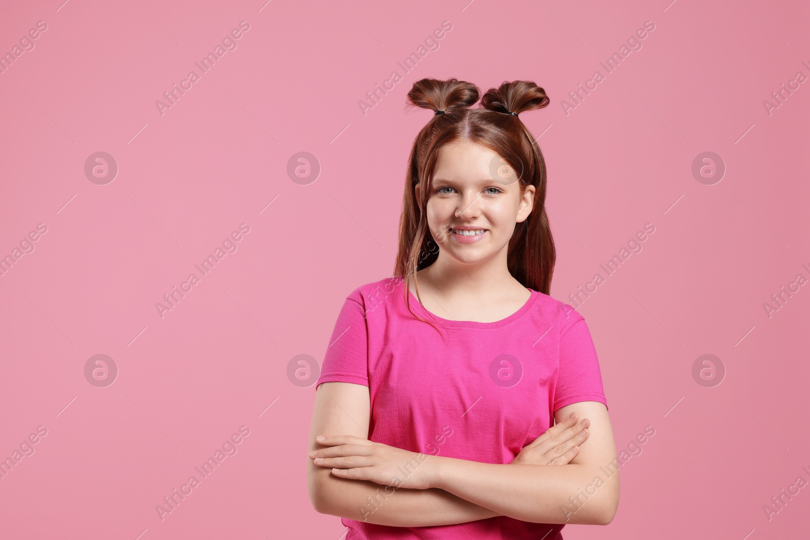 Photo of Portrait of teenage girl on pink background, space for text