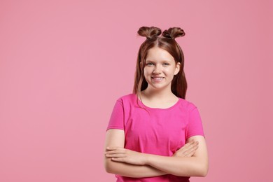 Portrait of teenage girl on pink background, space for text