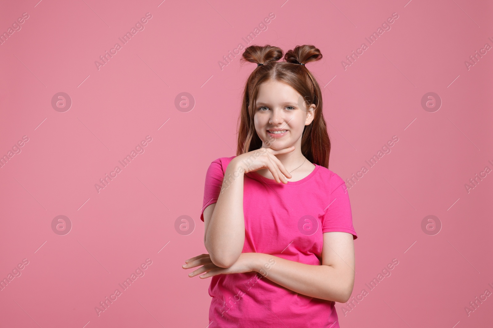 Photo of Portrait of teenage girl on pink background, space for text