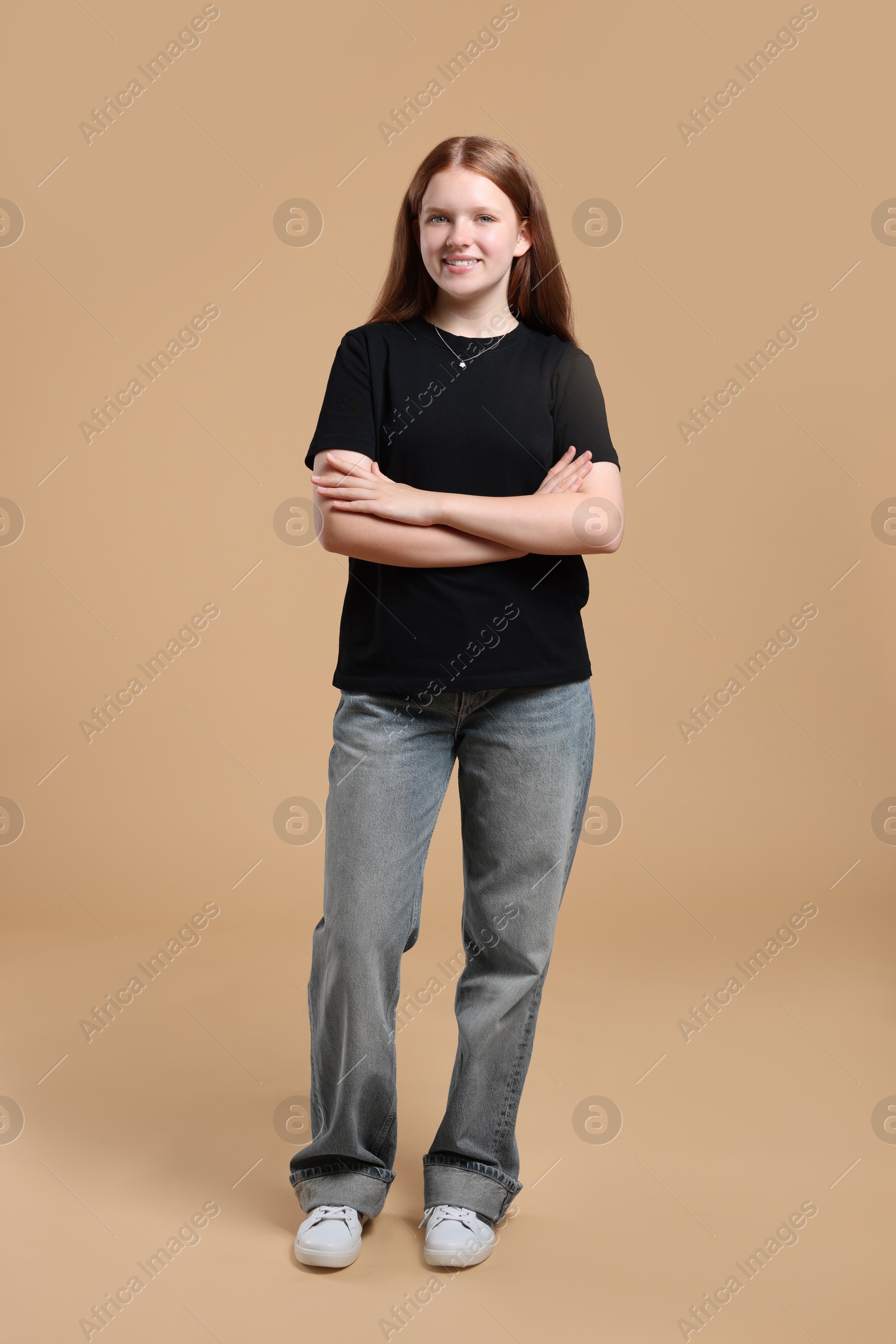 Photo of Full length portrait of teenage girl on beige background