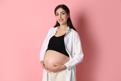 Photo of Portrait of beautiful pregnant woman on pink background