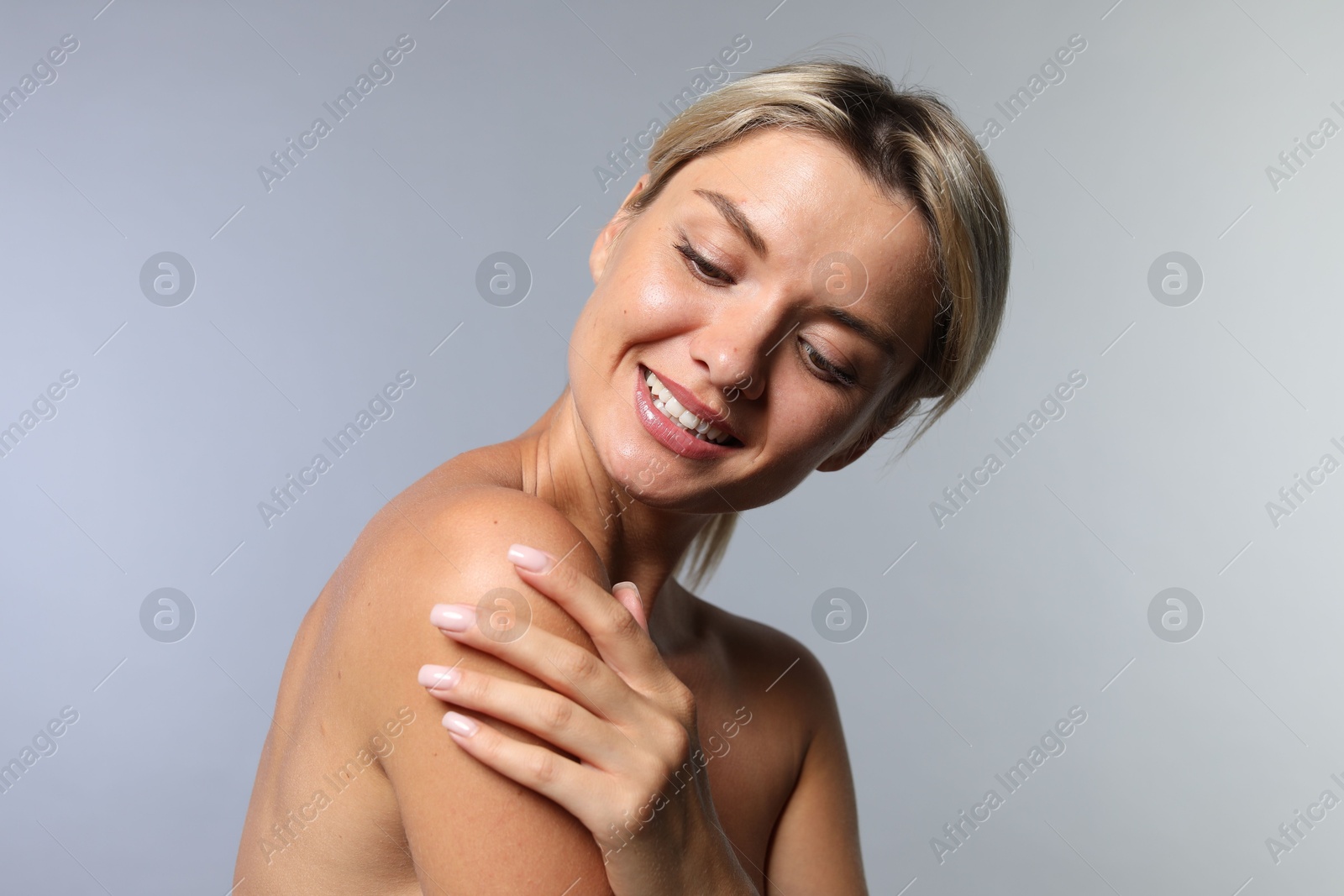 Photo of Cosmetology. Beautiful woman with perfect skin on grey background