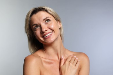 Photo of Cosmetology. Beautiful woman with perfect skin on grey background